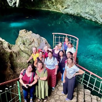 Group photo near the crystal-clear lagoon inside Los Tres Ojos park