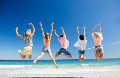 Portrait of friends posing at the beach on a sunny day
