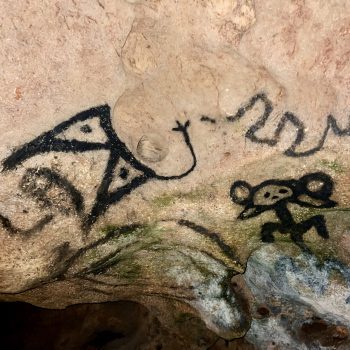 Ancient Taino cave drawings carved into the rock walls of the Cave of Wonders
