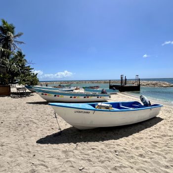 Colorful fishing boats resting on the beach under the Caribbean sun in La Romana