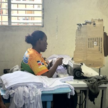 Woman sewing garments in a small handcrafted clothing workshop in La Romana