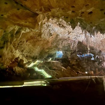 Illuminated pathway through stalactites and rock formations in the Cueva de las Maravillas