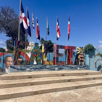 Monumental "La Caleta" sign with Dominican flags at the village entrance near La Romana