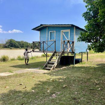 Small blue station next to the waterskiing lake with equipment and deck