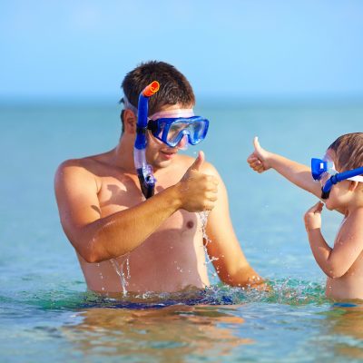 happy father and son snorkeling